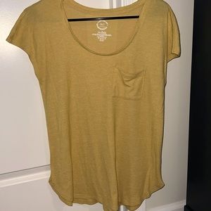 Soft tshirt material with rounded edges at the bottom. Mustard color